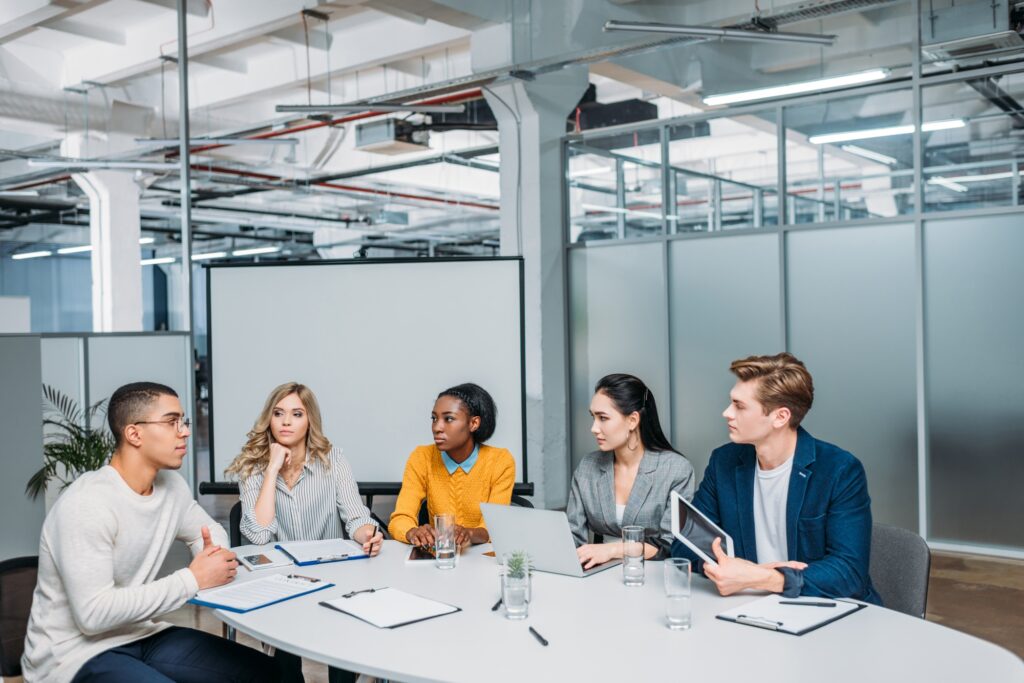 business partners having conversation at modern loft office conference hall