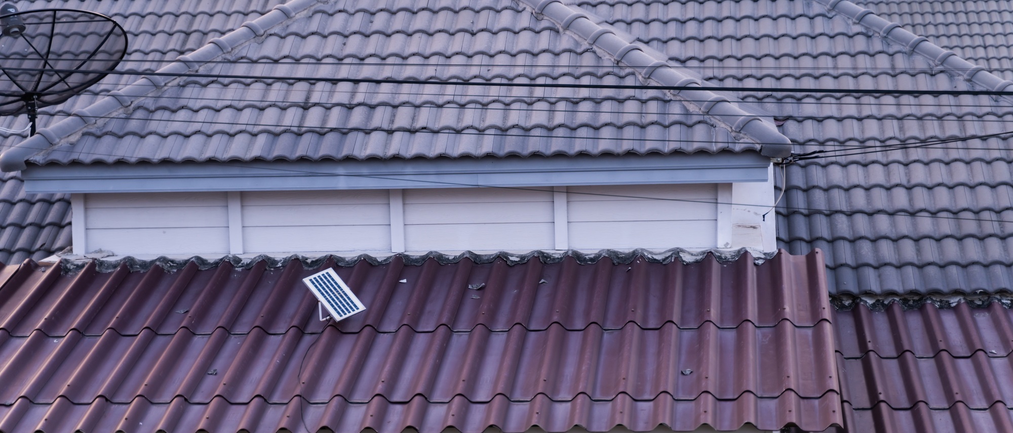 Close up of roof with small solar panel.
